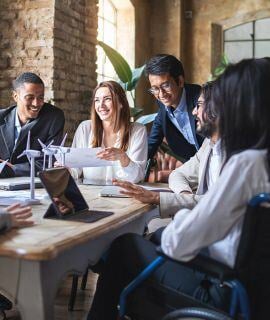 Professionals sitting around a conference table to create solutions for community-based child welfare at the annual symposium hosted by the National Center for Community-Based Child Welfare. 