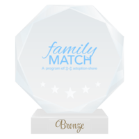 The Family Match professional logo printed on a round crystal trophy to represent their Bronze Professional Partner status with the National Center for Community-Based Child Welfare. 