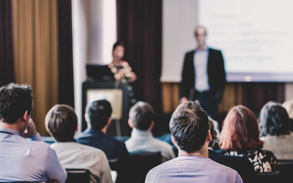 Expert speakers giving a presentation on innovative solutions for community-based child welfare at the annual symposium of the National Center for Community-Based Child Welfare. 